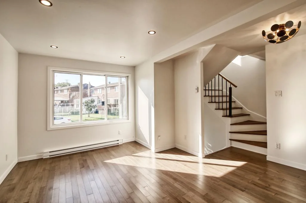 Sun-filled living room with refinished hardwood floors