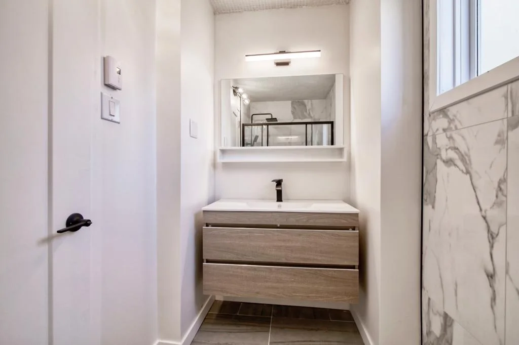 Floating wood vanity in the main bathroom