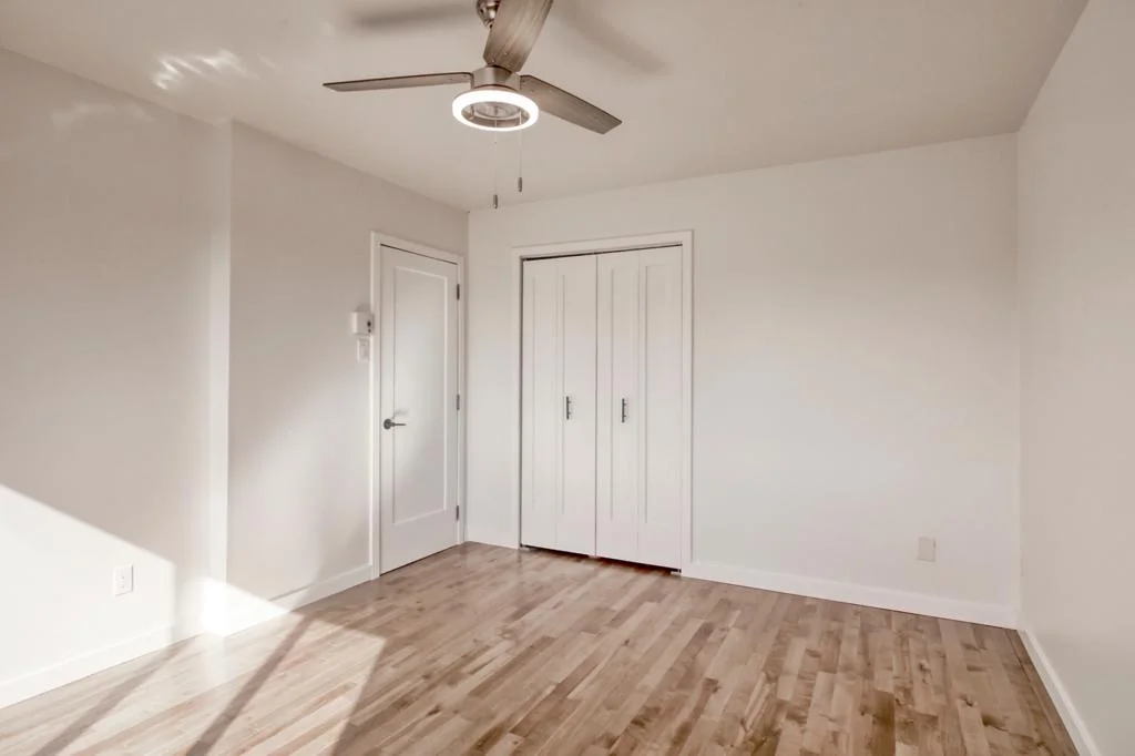 Bedroom with ceiling fan and double closet