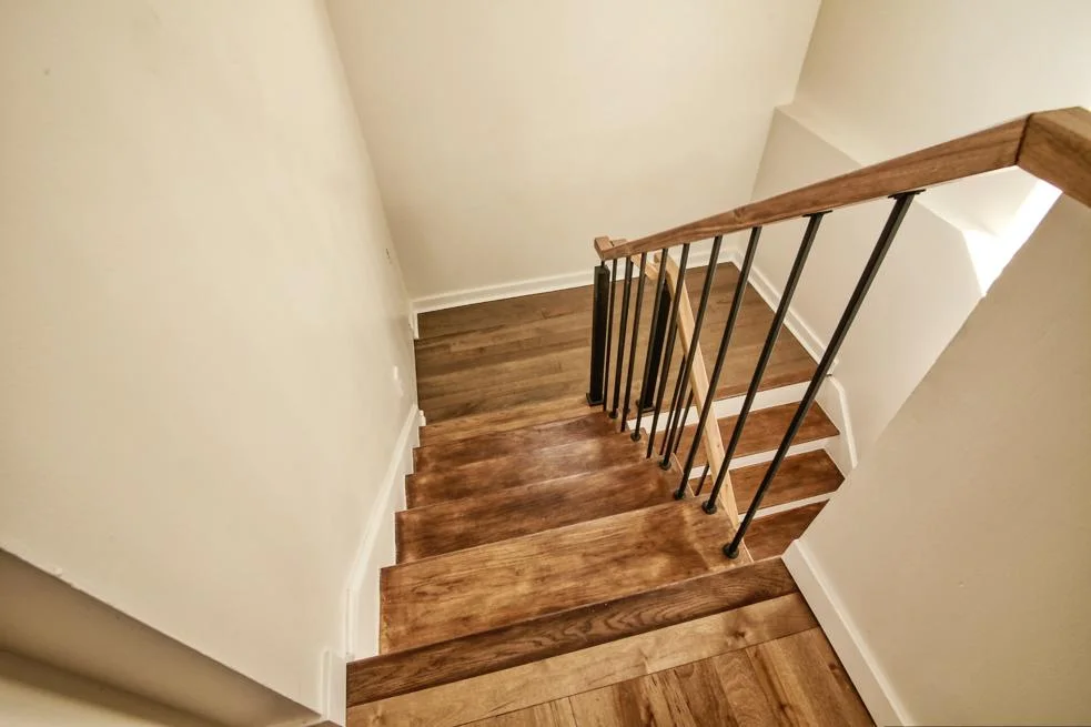 Staircase detail — oak treads and black spindles