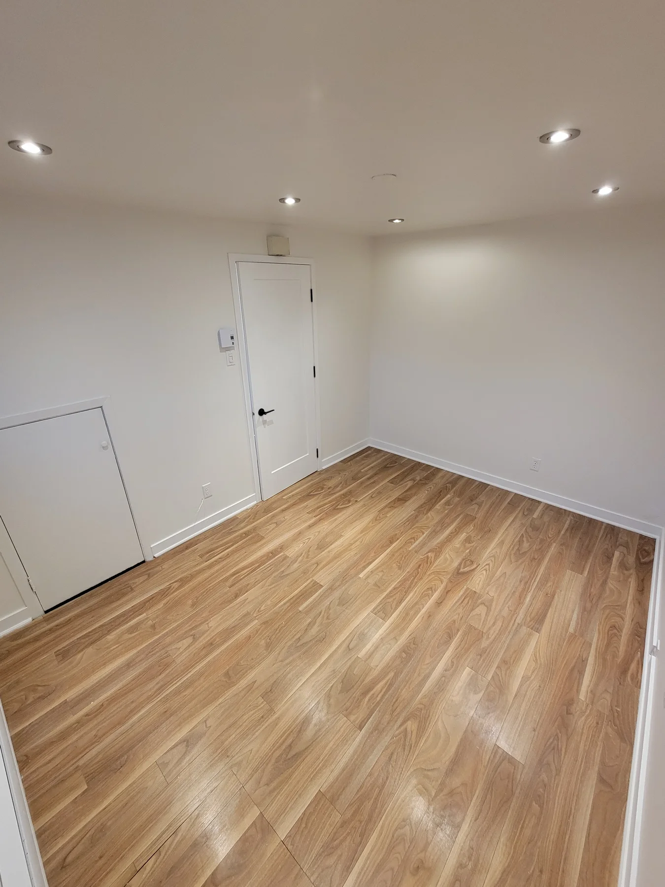Finished basement with recessed lighting throughout
